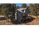 Charming two-story home with a spacious wooden deck and beautiful backyard at 6637 Berry Bush Ln, Evergreen, CO 80439