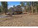 Charming two-story home with a spacious wooden deck and a lush, green backyard at 6637 Berry Bush Ln, Evergreen, CO 80439