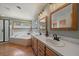 Double vanity bathroom with two sinks, tub, shower and wood frame mirrors at 6637 Berry Bush Ln, Evergreen, CO 80439