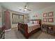 Cozy bedroom with a ceiling fan, a window, and lovely decor at 6637 Berry Bush Ln, Evergreen, CO 80439