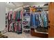 Walk-in closet complete with built-in shelving, hanging rods, and lots of storage space at 6637 Berry Bush Ln, Evergreen, CO 80439