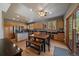 Open dining area with wood floors, wood cabinets, stainless appliances, and a walk-out to the balcony at 6637 Berry Bush Ln, Evergreen, CO 80439