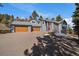 Stunning two-story home with a three-car garage and beautiful landscaping at 6637 Berry Bush Ln, Evergreen, CO 80439