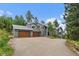 Charming two-story home with a three-car garage and well-maintained landscaping at 6637 Berry Bush Ln, Evergreen, CO 80439