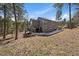 The back exterior of the two-story home features a porch and wooded back yard at 6637 Berry Bush Ln, Evergreen, CO 80439