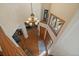 Bright two-story foyer with hardwood floors, chandelier, and large windows at 6637 Berry Bush Ln, Evergreen, CO 80439