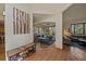 Open hallway showcases the living areas and artwork, highlighting the home's spacious design and hardwood floors at 6637 Berry Bush Ln, Evergreen, CO 80439