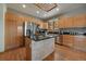 Modern kitchen with stainless steel appliances, wood cabinets, and a center island featuring counter seating at 6637 Berry Bush Ln, Evergreen, CO 80439