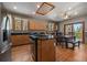 Bright kitchen with wood cabinets, a breakfast bar, stainless steel appliances, and an adjacent dining area at 6637 Berry Bush Ln, Evergreen, CO 80439