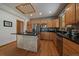 Well-lit kitchen with wood cabinets, black countertops, stainless steel appliances, and a tiled center island at 6637 Berry Bush Ln, Evergreen, CO 80439