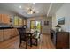 Open kitchen and dining area featuring wood cabinetry, stainless steel appliances, and access to an outdoor balcony at 6637 Berry Bush Ln, Evergreen, CO 80439