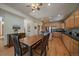 Spacious kitchen with wood cabinets, stainless steel appliances, and a dining table with chairs and a bench at 6637 Berry Bush Ln, Evergreen, CO 80439