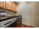 A laundry room includes wooden cabinets and a countertop with a washer and dryer at 6637 Berry Bush Ln, Evergreen, CO 80439