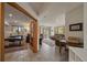 Open-concept living room with a view of nature, featuring a work space, and a sitting area at 6637 Berry Bush Ln, Evergreen, CO 80439