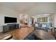 Spacious living room with hardwood floors, a large TV, and comfortable seating at 6637 Berry Bush Ln, Evergreen, CO 80439