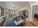 Open concept living space with hardwood floors, stone fireplace and large windows overlooking the trees at 6637 Berry Bush Ln, Evergreen, CO 80439