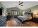 Inviting main bedroom with hardwood floors, ceiling fan and view of the tree tops at 6637 Berry Bush Ln, Evergreen, CO 80439