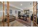 Bright home office with plenty of natural light, built-in bookshelves, and modern furniture at 6637 Berry Bush Ln, Evergreen, CO 80439