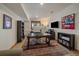 Bright home office with plenty of natural light, built-in bookshelves, and modern furniture at 6637 Berry Bush Ln, Evergreen, CO 80439