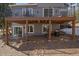 A covered patio offers a relaxed outdoor living space with comfortable seating and a fire pit at 6637 Berry Bush Ln, Evergreen, CO 80439