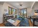 Bright playroom with large windows, a sink, and access to a balcony with scenic views at 6637 Berry Bush Ln, Evergreen, CO 80439