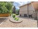 Landscaped backyard with flower beds, gravel, and outdoor grilling area at 20886 Parliament Pl, Parker, CO 80138