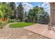 Landscaped backyard with a well-maintained lawn, patio, and mature trees providing privacy at 20886 Parliament Pl, Parker, CO 80138