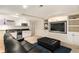 Finished basement featuring a wet bar, large TV, and leather seating at 20886 Parliament Pl, Parker, CO 80138