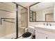 Bathroom featuring a glass-enclosed shower with a bench, safety bars, and modern fixtures at 20886 Parliament Pl, Parker, CO 80138