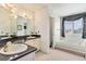 Elegant bathroom featuring double sinks and a separate tub at 20886 Parliament Pl, Parker, CO 80138