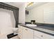 Well-lit bathroom featuring a sink with cabinetry and a toilet at 20886 Parliament Pl, Parker, CO 80138