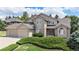 Attractive two-story home with brick and siding, well-maintained landscaping, and attached garage at 20886 Parliament Pl, Parker, CO 80138