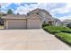 A beautiful home featuring a spacious three-car garage and meticulously kept landscaping at 20886 Parliament Pl, Parker, CO 80138
