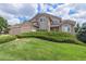 Landscaped front yard with green lawn and bushes framing a two-story home at 20886 Parliament Pl, Parker, CO 80138