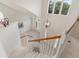 Bright foyer featuring large windows, chandelier, and white staircase at 20886 Parliament Pl, Parker, CO 80138