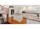 Well-lit kitchen with an island, a white refrigerator, and modern appliances at 20886 Parliament Pl, Parker, CO 80138