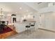 Eat-in kitchen with a breakfast bar, white cabinets, and a hardwood floor dining area at 20886 Parliament Pl, Parker, CO 80138