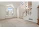 Bright living room with high ceilings, large windows, and a staircase leading to upper floor at 20886 Parliament Pl, Parker, CO 80138