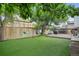 Backyard with artificial grass, wood fence, deck and swing set, creating a Gathering-friendly outdoor space at 1102 Conifer Ct, Highlands Ranch, CO 80126