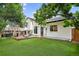 Backyard featuring a wooden deck and lush artificial grass, ideal for outdoor activities at 1102 Conifer Ct, Highlands Ranch, CO 80126