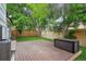 Backyard featuring artificial grass, a deck, and storage box, perfect for easy maintenance and outdoor storage at 1102 Conifer Ct, Highlands Ranch, CO 80126
