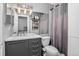 Updated bathroom with a gray vanity, ample lighting, and a shower-tub combination at 1102 Conifer Ct, Highlands Ranch, CO 80126