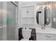 Updated bathroom features shower, updated vanity with storage, unique fixtures, and decorative wall features at 1102 Conifer Ct, Highlands Ranch, CO 80126