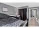 The bedroom has wood-look floors, a window, and is next to a hallway at 1102 Conifer Ct, Highlands Ranch, CO 80126