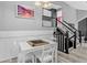 Bright dining area featuring white furniture, a game board, and stairs leading to the second floor at 1102 Conifer Ct, Highlands Ranch, CO 80126