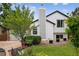 Charming exterior with a well-manicured lawn, flower beds, and classic white siding at 1102 Conifer Ct, Highlands Ranch, CO 80126