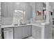 Modern kitchen with gray cabinets, stainless steel appliances, and a bright white countertop at 1102 Conifer Ct, Highlands Ranch, CO 80126