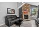 Inviting living room features a stone fireplace, vaulted ceilings, and neutral decor at 1102 Conifer Ct, Highlands Ranch, CO 80126