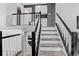 Staircase featuring black handrails and white risers at 1102 Conifer Ct, Highlands Ranch, CO 80126