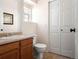 Well-lit bathroom featuring a toilet, sink, and a closet at 9150 Gale Blvd # 1, Thornton, CO 80260